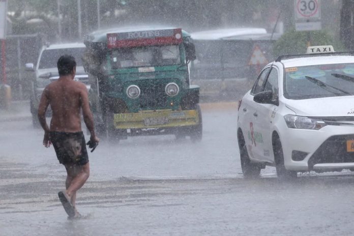 RAINY DAYS. A man braves the heavy downpour as he crosses the street along E. Quirino Avenue in Davao City. Davao City is experiencing rainy days due to a tropical depression “Marcel” which is expected to landfall in Hinatuan, Surigao del Sur. Lean Daval Jr.