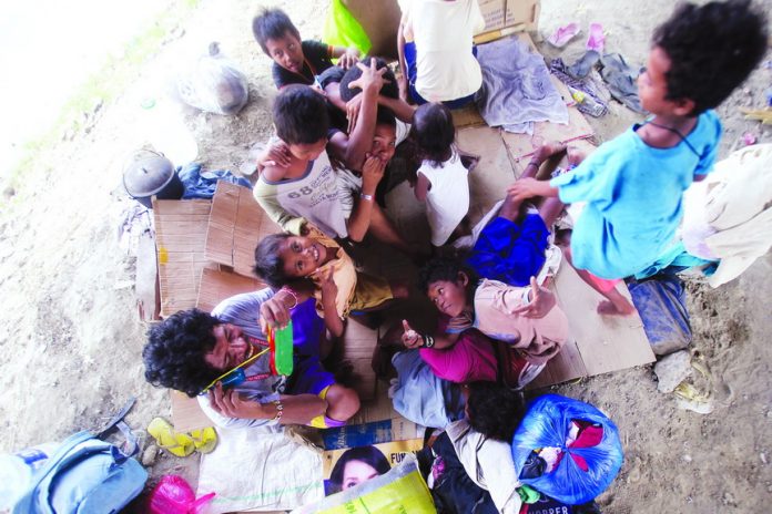 INNOCENT BLISS. Happiness is written all over the faces of Lumad children from Agusan despite the hardship they are experiencing during their sojourn in Davao City to ask for Christmas gifts. These Lumads are temporarily staying under the flyover in Agdao. LEAN DAVAL JR.