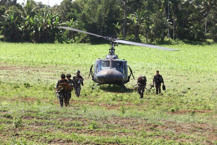 Army soldiers disembark from a Huey chopper Monday (28 November 2016) as they join the fight against the Maute group in Butig, Lanao del Sur. The group linked to ISIS has once again occupied the town center. MindaNews photo by Ferdinandh Cabrera