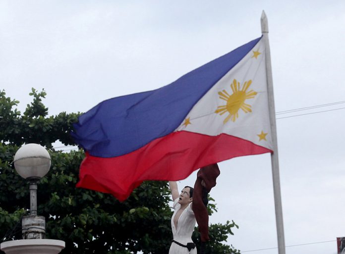 AUTHENTIC HERO. A Philippine flag waves prominently in front of the statue of Andres Bonifacio, considered as the father of the Philippine revolution, at his monument along the junction of C.M. Recto Avenue and Magallanes Street in Davao City yesterday. The whole nation will be commemorating the 153 birthday of Bonifacio today. LEAN DAVAL JR.