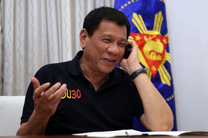 President Rodrigo Roa Duterte congratulates United States of America President-elect Donald Trump through a phone call at Legaspi Suites in Davao City on December 3, 2016. RICHARD MADELO/Presidential Photo