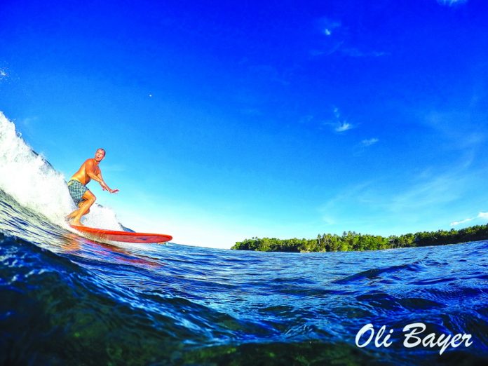 Clear blue skies and riding glassy waves make up the better part of living the island life in Siargao. Photo by Oli Bayer.