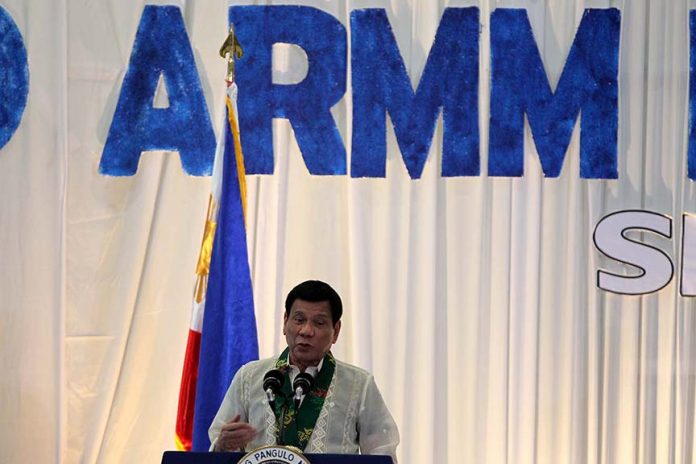 DUTERTE BEFORE ARMM LGUS. President Rodrigo R. Duterte speaks before government officials of the 3rd Autonomous Region in Muslim Mindanao (ARMM) Local Government Summit held at SM Lanang Premier’s SMX Convention Center on Thursday night. LEAN DAVAL JR.