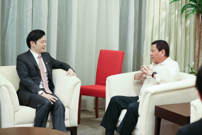 TOP-LEVEL WELCOME. President Rodrigo R. Duterte is welcomed by Singapore Minister of National Development Lawrence Wong upon his arrival at the Changi Airport in Singapore yesterday morning. KING RODRIGUEZ/Presidential Photo