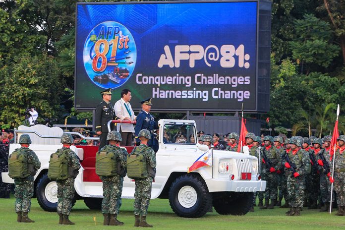 VIEWING THE TROOPS. President Rodrigo Roa Duterte leads the inspection of troops during the 81st anniversary celebration of the Armed Forces of the Philippines at Camp Aguinaldo in Quezon City on Wednesday. REY BANIQUET/Presidential Photo