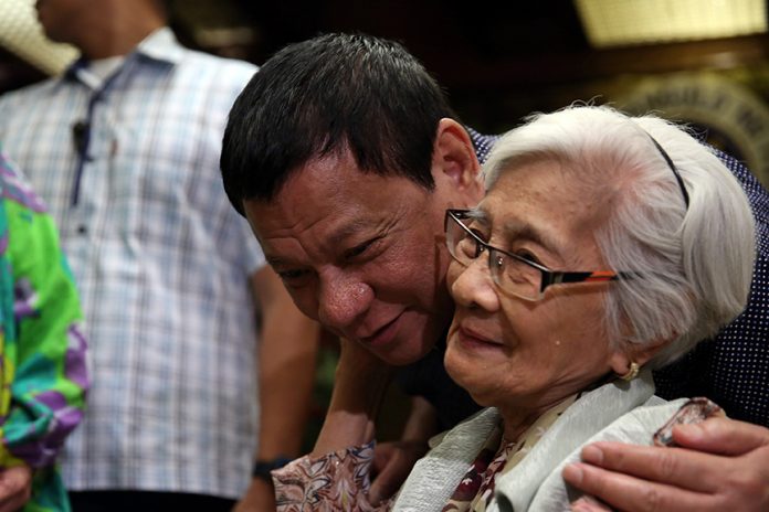 WISH FULFILLED. President Rodrigo Roa Duterte grants the wish of a senior citizen to attend the Christmas party with the President in Malacañan on Tuesday evening. RICHARD MADELO/Presidential Photo