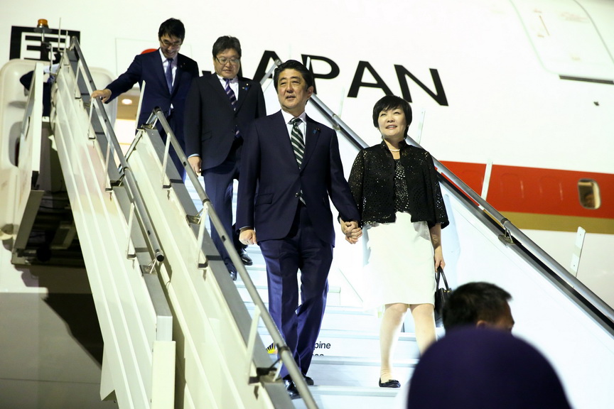 Japan Prime Minister Shinzo Abe and his wife Akie Abe make disembark from the Japanese Air Force One upon their arrival at the Francisco Bangoy International Airport in Davao City on the evening of January 12, 2017. Davao City is the final stop of Japan Prime Minister's two-day official visit to the Philippines. KARL NORMAN ALONZO/Presidential Photo