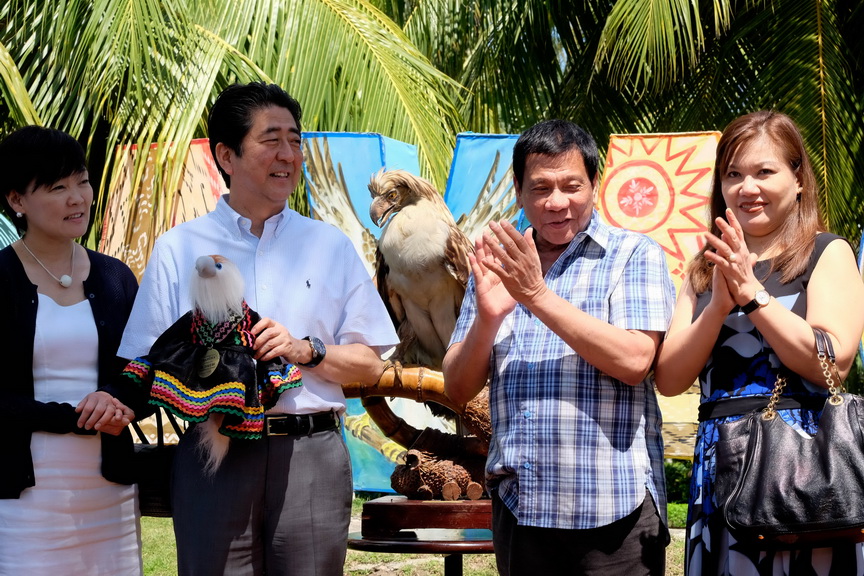 President Rodrigo Roa Duterte and his common-law wife Honeylet Avanceña applaud after Japan Prime Minister Shinzo Abe receives the stuffed toy of the Philippine Eagle named ‘Sakura’during a ceremony at the Waterfront Hotel in Davao City on January 13, 2017. The name was Japanese-inspired after the Prime Minister Abe has provided support to the Philippine Eagle Foundation, the organization that takes care of the endangered species. Also in the photo are Finance Secretary Carlos Dominguez III and the Prime Minister's wife, Akie Abe. SIMEON CELI JR./Presidential Photo