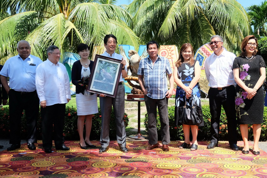 Japan Prime Minister Shinzo Abe and his wife Akie Abe pose with President Rodrigo Roa Duterte and his common-law wife Honeylet Avanceña after they received the stuffed toy and the framed photo of the Philippine Eagle named ‘Sakura’during a ceremony at the Waterfront Hotel in Davao City on January 13, 2017. The name was Japanese-inspired after the Prime Minister of Japan has provided support to the Philippine Eagle Foundation, the organization that takes care of the endangered species. Also in the photo are Executive Secretary Salvador Medialdea and Finance Secretary Carlos Dominguez III. SIMEON CELI JR./Presidential Photo