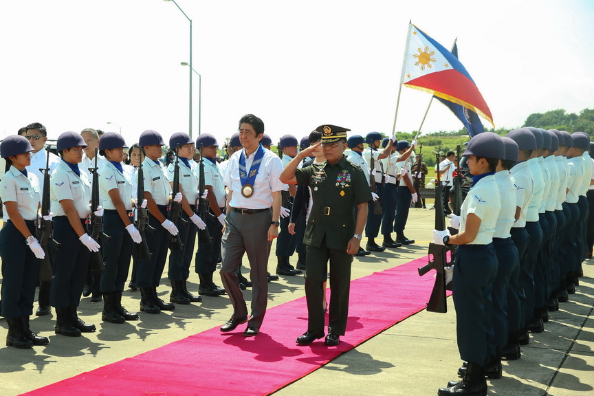 Japanese Prime Minister Shinzo Abe is accompanied by Major General Leonardo Guerrero of the Philippine Army as he walks past honor guards prior to his departure at the Francisco Bangoy International Airport in Davao City on January 13, 2017 following a successful state visit to the Philippines. KARL NORMAN ALONZO/Presidential Photo