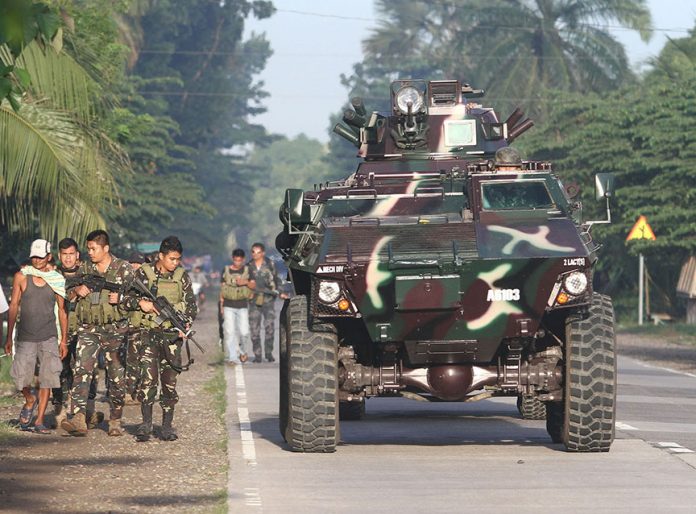 Combined elements from the Army and the Cotabato Provincial Police Office Office patrol the national highway near Amas Capitol Compound in Kidapawan City as they search for the 158 escaped inmates following a raid by at least 100 armed men at the provincial jail inside the capitol compound dawn on Wednesday (4 January 2017). Mindanews Photo