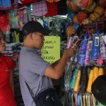 HOT COMMODITY. A man browses at a collection of umbrellas on display at the sidewalk along San Pedro Street in Davao City yesterday. Umbrellas are in demand nowadays due to the constant heavy downpour brought by the low pressure area (LPA) affecting the city. LEAN DAVAL JR.