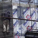 DAREDEVIL ACT. A worker ignores the danger of falling as he scales a building through metal railing without protective gears along R. Magsaysay Avenue in Davao City yesterday. LEAN DAVAL JR.