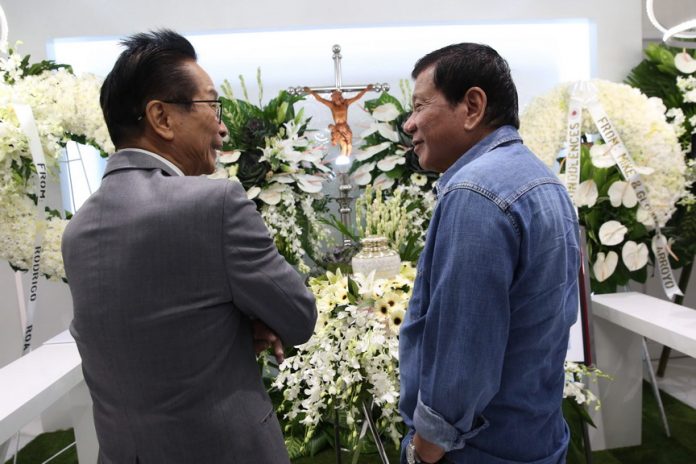 IN MOURNING. President Rodrigo Duterte condoles with Chief Legal Counsel Salvador Panelo whose son, Carlo, passed away recently. The President visited the wake of Panelo's son at the Cosmopolitan Memorial Chapels and Crematory in Quezon City on Friday evening. ALBERT ALCAIN/Presidential Photo