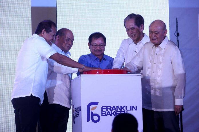 FRESH START. Franklin Baker Company of the Philippines president and chief executive officer Jerome Lorenzo (second from left), vice Chairman Peter D. Garrucho Jr. (rightmost), independent director Senen Bacani (second from right) and Darong plant manager Ronaldo Santos (leftmost), together with Department of Agriculture (DA) secretary Emmanuel Piñol, lead the ceremonial start of plant operations during yesterday inauguration of the company’s Darong plant in Darong, Sta. Cruz, Davao del Sur. LEAN DAVAL JR.