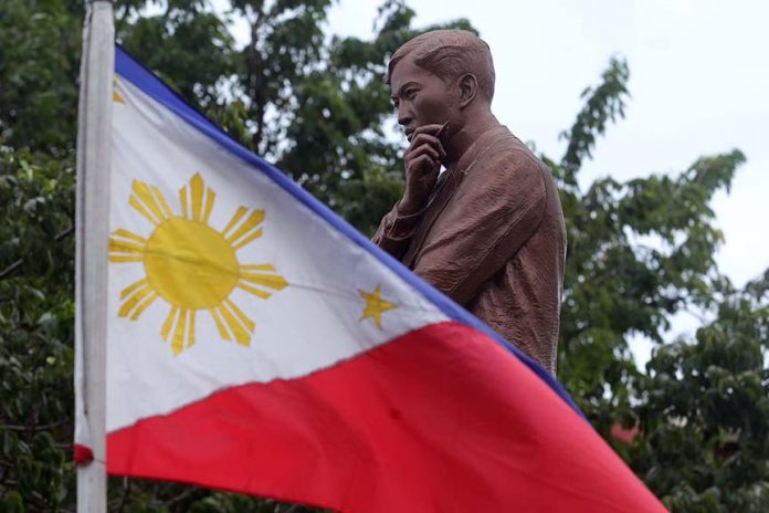 RIZAL DAY. A Philippine flag prominently flies beside the statue of national hero Jose Rizal at Rizal Park in Davao City. The nation, led by President Duterte, commemorated the 120th Rizal Day yesterday. LEAN DAVAL JR.