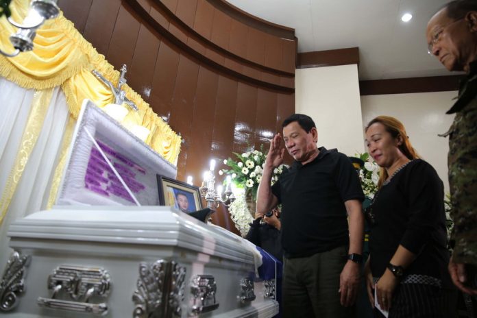 HIGHEST RESPECT. President Rodrigo Duterte salutes Captain Clinton Capio during a wake visit at the mortuary of the Libingan ng mga Bayani in Fort Bonifacio on Monday night. Capio, a Philippine Military Academy Class 2006, was killed in a clash with the Abu Saya- members last Thursday. KING RODRIGUEZ/ Presidential Photos