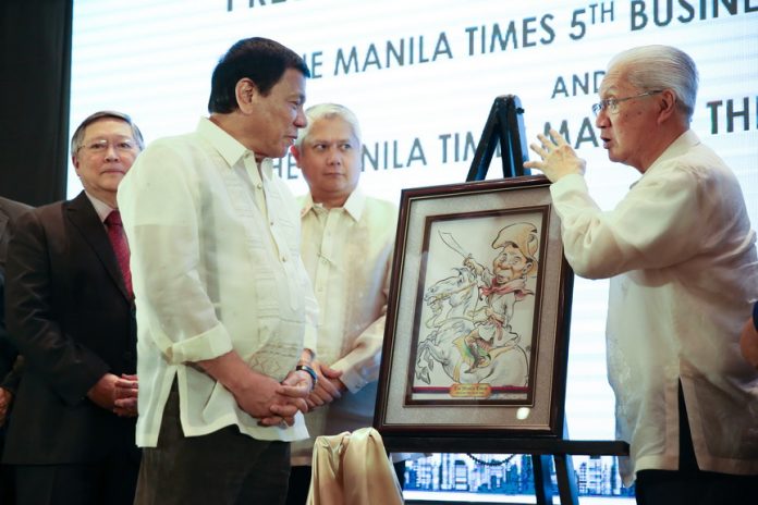 President Rodrigo Roa Duterte looks on as Manila Times Chairman Emeritus Dante Ang and President and CEO and Executive Editor Dante Francis Ang II unveils the caricature of the President who was awarded as the ‘Manila Times Man of The Year’ during the 5th Manila Times Business Forum at Marco Polo Hotel in Davao City on February 10, 2016. TOTO LOZANO/Presidential Photo