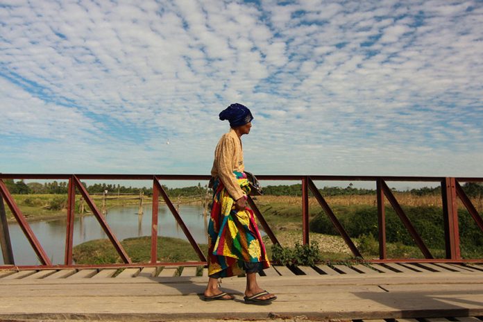 A Moro resident of Barangay Tukanalipao crosses a safer and wider bridge in Mamasapano, Maguindanao province. The bridge was constructed after the deadly encounter between members of the Moro Islamic Liberation Front and PNP Special Action Force two years ago. MindaNews File Photo