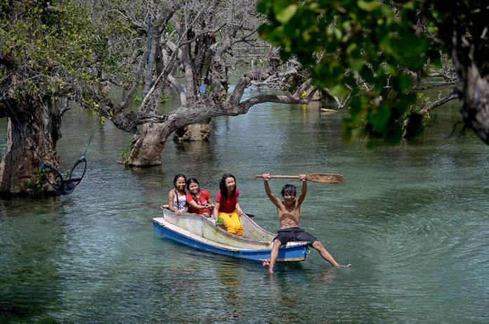 HIDDEN GETAWAY. Local tourists enjoy the crystal clear water under the shades of century-old mangrove trees of Bong Feo resort in Barangay Lago, Glan, Sarangani province during the weekend. Just a 30-minute ride from General Santos City, this mangrove surrounded resort is a perfect getaway for family and backpackers. (Cocoy Sexcion for SARANGANI INFORMATION OFFICE)