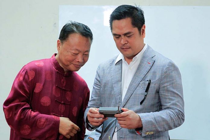 QUALITY GEAR. Presidential Communications Secretary Martin Andanar and Chinese Ambassador to the Philippines Zhao Jianhua try out the operational capability of one of the radios that the Chinese government donated for the government-owned media groups under the Presidential Communications Operations Office after a simple turn over ceremony at Malacañan Palace yesterday. EXEQUIEL SUPERA/Presidential Photo