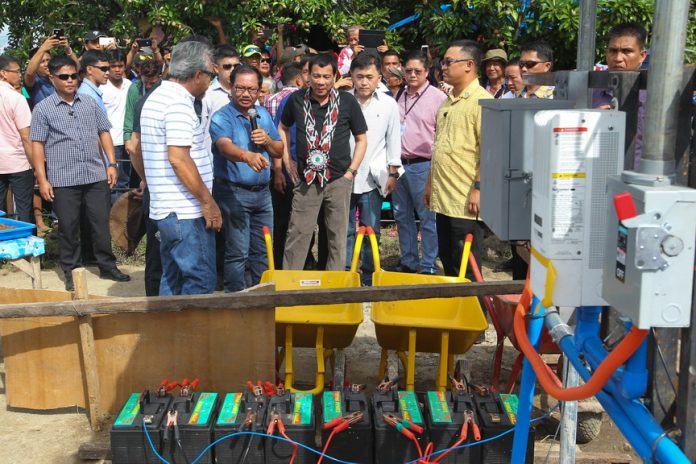 UP CLOSE. President Rodrigo Duterte looks on as Agriculture Secretary Emmanuel Piñol showS one of the components of the M’lang Solar Powered Irrigation System during its inauguration in Barangay New Janiuay in M'lang, North Cotabato on Friday. SIMEON CELI JR./Presidential Photo