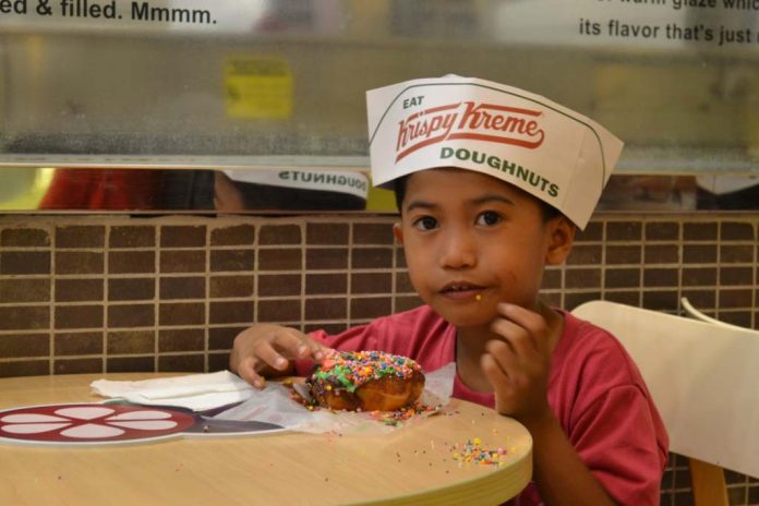 Junior Doughnut Master for a day. A boy from Providence Home of St. Joseph munches the glazed doughnut he has decorated during the fun doughnut tour at Krispy Kreme SM City Davao on March 16, 2017. JERMAINE L. DELA CRUZ