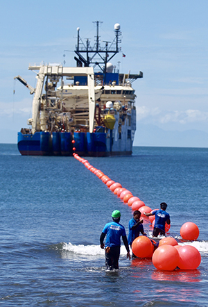 ENHANCED CAPABILITY. A ship carrying a multi-billion dollar underwater cable which was connected to the Globe Telecommunications Power Feed Equipment Site in Davao City that will link to four territories in Indonesia, Guam, Hawaii and Los Angeles docks at the seafront in Talomo on Friday during the Southeast Asia-United States Cable Landing Ceremony. The new cable system will be fully operational by yearend. LEAN DAVAL JR.