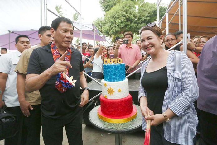 BIRTHDAY CAKE. A day after celebrating his 72nd birthday, President Duterte receives a cake from Socorro Municipal Mayor Ma. Fe Brondial during his attendance to the People’s Day celebration of the town of Socorro, Oriental Mindoro at Barangay Batong Dalig on Wednesday afternoon. TOTO LOZANO/Presidential Photo