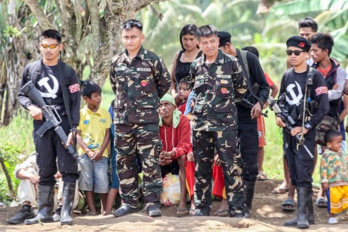 Members of the New People’s Army guard their “prisoners of war,” Pfc Samuel Garay (2nd from L) and Sgt Solaiman Calocop (3rd from L) of the 39th Infantry Battalion before the two soldiers were released to government officials and peace advocates in the hinterlands of Matanao, Davao del Sur on April 19, 2017. Garay and Calocop were captured by the NPA on February 2, 2017 in Columbio, Sultan Kudarat while they were on their way to Makilala, North Cotabato. MindaNews photo by Manman Dejeto