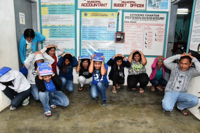 EARTHQUAKE DRILL. Employees of the local government of Kiamba town in Sarangani province participate in the 1st Quarter Earthquake Drill of 2017 as their way of showing support to the National Disaster Risk Reduction and Management Council's project for disaster preparedness themed Bida ang Handa. In this activity on March 31, government employees ducked, covered, and held just like they would if a real earthquake had happened. Emergency rescuers showed proper procedures for evacuating an earthquake victim. (Avery Rotciv Valois Camposano-JP Belmonte/KIAMBA INFORMATION OFFICE)