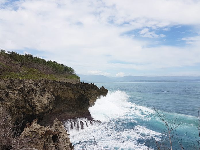 With safety as the utmost precaution, if you’re wearing shoes and can brave the jagged limestone rocks, you can see a little bit more of the ocean at the viewing deck at Pusan Point. Photo by Elli Pangue