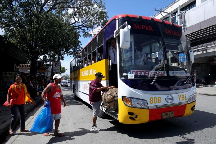 ILLEGAL LOADING. A bus bound for Koronadal City in South Cotabato picks up passengers outside the Davao City Overland Transport Terminal on Tuesday. DCOTT manager Aiza Yusoph has said she is discouraging bus operators from picking up passengers outside the terminal or along the highway for additional safety measures. LEAN DAVAL JR.