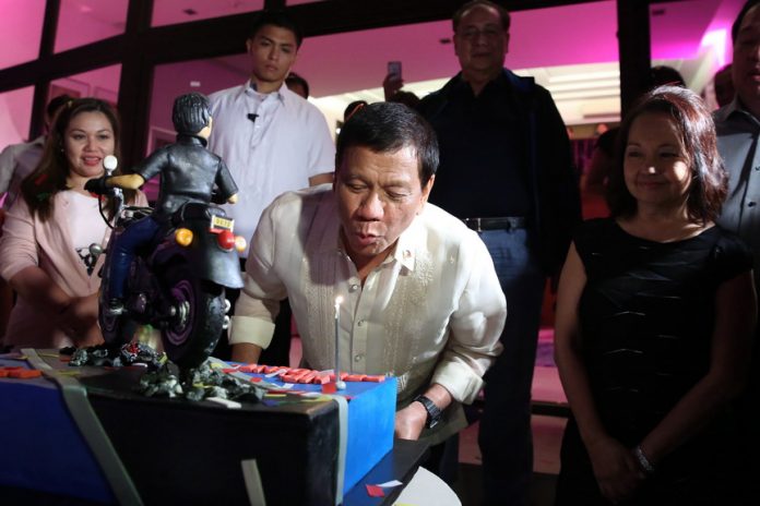 FROM ONE LEADER TO ANOTHER. President Rodrigo Roa Duterte blows the candle of the birthday cake given by former President and incumbent Pampanga Second District Representative Gloria Arroyo during the former president's 70th birthday celebration at La Vista Subdivision in Quezon City on Wednesday night. The President celebrated his 72nd birthday on March 28, 2017. Also in the photo are the president's partner Honeylet Avanceña and the former president's husband Jose Miguel Arroyo. ALFRED FRIAS/Presidential Photo