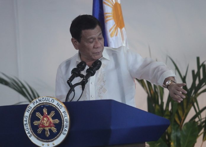 MADE IN RP. President Rodrigo Duterte shows his Ibarra watch and encourages his cabinet members to patronize Philippine made products during a pre-departure speech before leaving for a state visit to Russia at the Davao International Airport in Davao City on Monday. LEAN DAVAL JR.