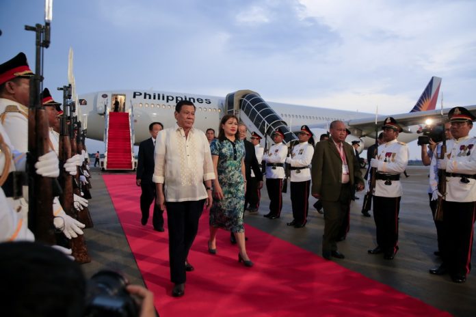 President Rodrigo Roa Duterte is accompanied by his partner Honeylet as he walks past honor guards upon his arrival at the Phnom Penh International Airport in Cambodia on May 10, 2017 for his attendance to the World Economic Forum (WEF) on ASEAN 2017 on May 11. PRESIDENTIAL PHOTO