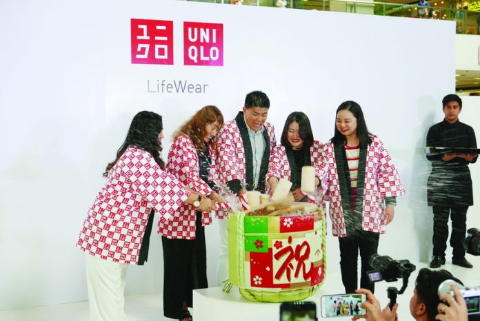 Katsumi Kubota, Chief Operating Officer, Uniqlo Philippines (center) opens the ceremonial sake barrel together with (from left) Uniqlo Area Manager Binnah Kim, Japanese Consul to Davao, Tomoko Dodo, Uniqlo Store Manager Rose Velardo and SM Lanang Premier Operations Manager Therese Manalo ((right)