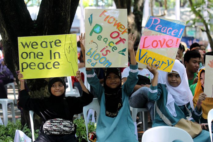 THE MEDIUM IS THE MESSAGE. Young Muslim girls hold placards on peace and unity during the peace walk for the prevention of violent extremism in time for the 4th Annual Commemoration of the Declaration of World Peace held at the People’s Park in Davao City on Tuesday. The event was organized by Heavenly Culture, World Peace, Restoration of Light (HWPL) with the collaboration of the 11 tribes of Davao and Madrasah Comprehensive Development and Promotion Program (MCDPP). LEAN DAVAL JR.