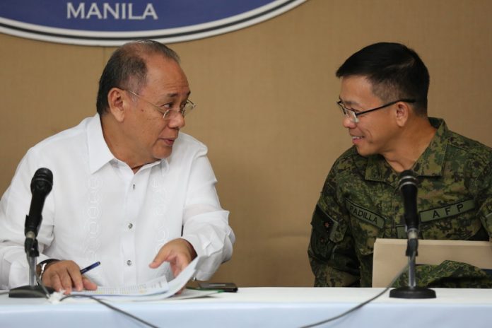 IN THE INTERIM. Presidential spokesperson Ernesto Abella and Armed Forces of the Philippines Spokesperson Brigadier General Restituto Padilla engage in a conversation on the sidelines of the 'Mindanao Hour' at the New Executive Building, Malacañang Complex, Manila on Monday. PRESIDENTIAL PHOTO