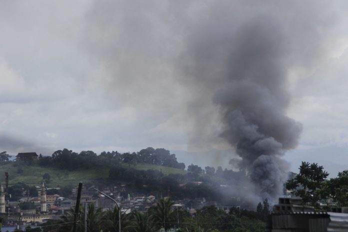 Smoke billows up in a portion of Marawi City that was hit by rockets fired from a gunship as fighting between government forces and the Maute group entered its ninth day on Wednesday (31 May 2017). MindaNews photo by H. Marcos C. Mordeno