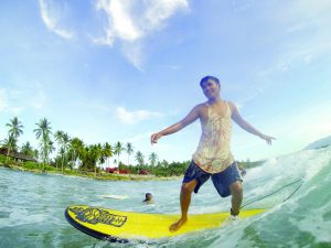 GOODBYE WAVES. It’s almost nearing flat season. Dahican local surfer Mark Bucong slides through the last remaining swell before school starts. Photo by Dandan Consigna