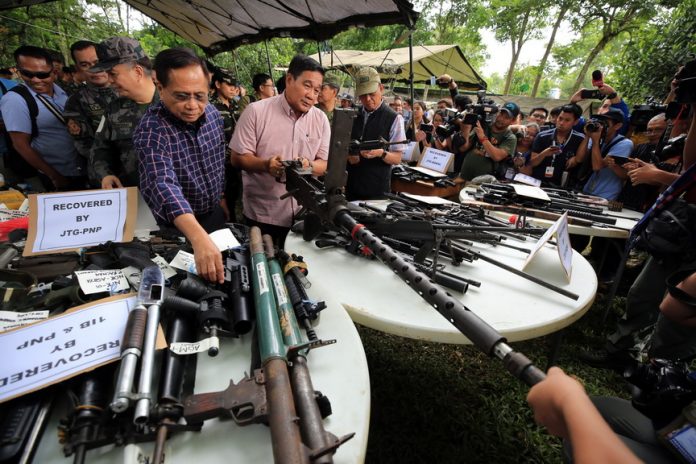 IMPRESSIVE WEAPONRY. National Security Adviser Hermogenes Esperon (center), Presidential Adviser on the Peace Process Secretary Jesus Dureza (left) and Defense Secretary Delfin Lorenzana inspect the recovered firearms from local terrorists in Marawi City over the weekend. PRESIDENTIAL PHOTOGRAPHERS