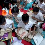 QUICK READ. Students from Euroasia Learning Center and Values School browse over the books distributed to them during the National Children’s Bookreading Day at the Annex of SM City Davao on Tuesday. N