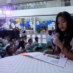 TAKING THE LEAD. Presidential daughter, Veronica ‘Kitty’ Duterte, reads a book entitled ‘Two Friends, One World’ to the students of Euroasia Learning Center and Values School during the National Childr