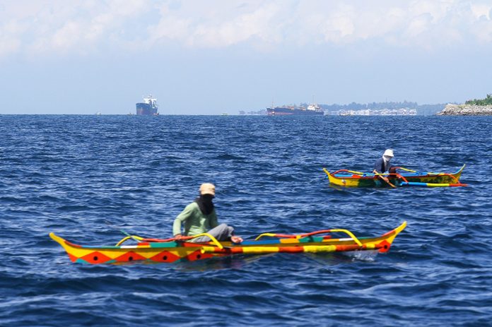 Fishermen aboard small but colorful fishing boats try to catch fish at the Davao Gulf near Island Garden City of Samal (IGaCoS) on Saturday. LEAN DAVAL JR.