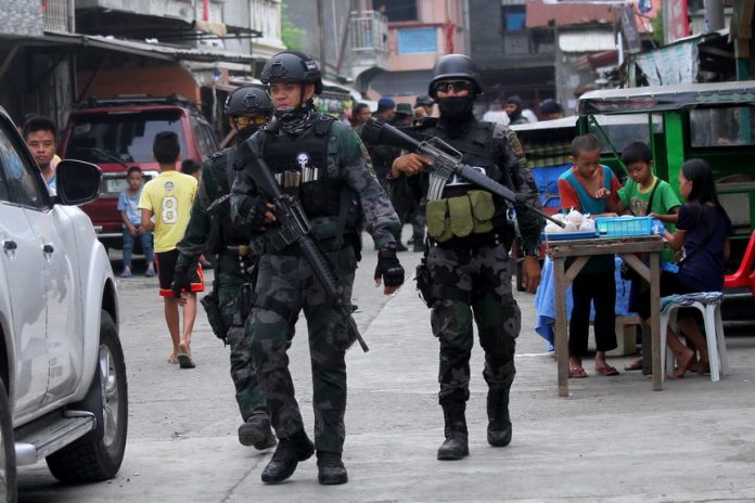 SECURITY CHECK. Members of the Davao City Police Office’s Special Weapons and Tactics unit, together with other police personnel and Task Force Davao, conduct a surprise a ‘saturation operation’ in Mini-forest, Quezon Blvd., Davao City on Saturday morning. LEAN DAVAL JR.