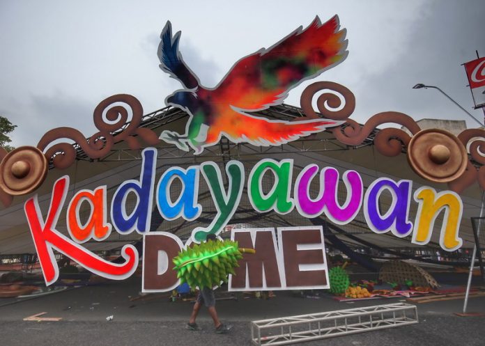 ADDITIONAL PIECE. A worker holding a decorative plastic Durian fruit walks by the Kadayawan dome which is being assembled and will be used for Kadayawan sa Davao 2017 activities at San Pedro Square in Davao City on Tuesday. LEAN DAVAL JR.