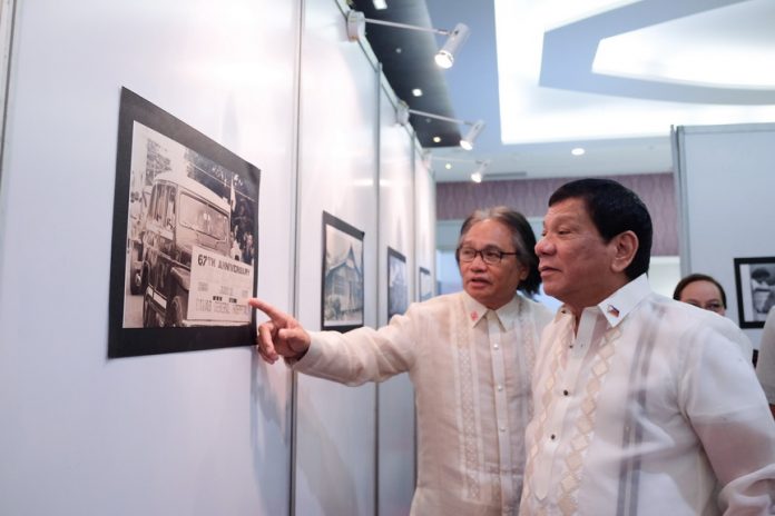 OVERVIEW. President Duterte is given a tour of the photo exhibit by Southern Philippines Medical Center Chief Dr. Leopoldo Vega, during the SPMC Centennial Celebration at the SMX Convention Center in Davao City on Friday evening. KIWI BULACLAC/PRESIDENTIAL PHOTO