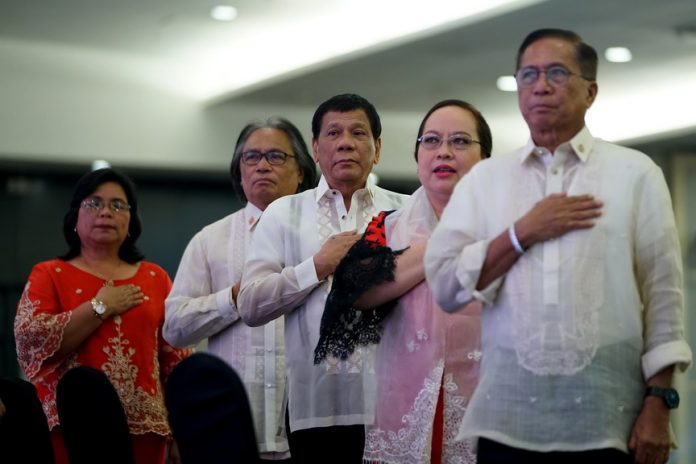 SETTING THE TONE. President Duterte sings the Philippine national anthem during the Southern Philippines Medical Center (SPMC) Centennial Celebration at the SMX Convention Center in Davao City on Friday night. Also in the photo are Davao City Councilor Dr. Mary Joselle Villafuerte, SPMC Chief Dr. Leopoldo Vega, Health Secretary Paulyn Ubial and Presidential Adviser on the Peace Process Jesus Dureza. RENE LUMAWAG/PRESIDENTIAL PHOTO