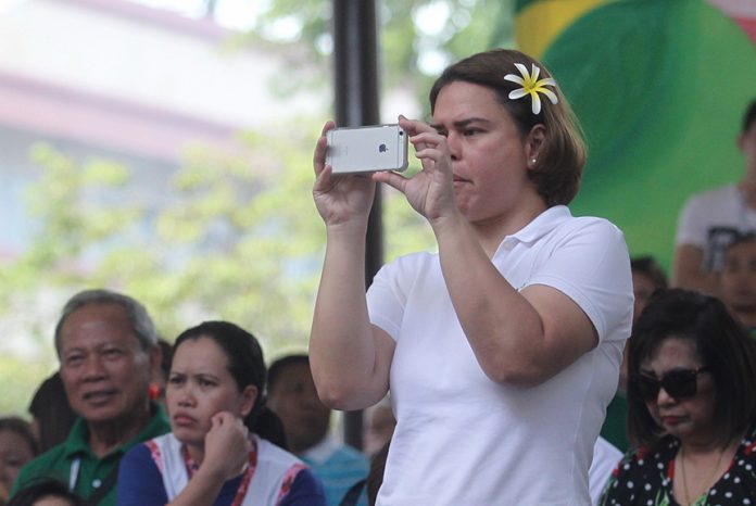 BEHIND THE LENS. Davao City Mayor Sara Duterte-Carpio takes photos of the colorful floral floats during 'Pamulak sa Kadayawan', the culminating event of the week-long Kadayawan sa Davao 2017, at Kadayawan square along San Pedro Street on Sunday. This year's festivity has posted an online reach of 2.6 million people according to the officials of Davao Digital Influencers, the official social media partner of the Kadayawan sa Davao 2017. LEAN DAVAL JR.